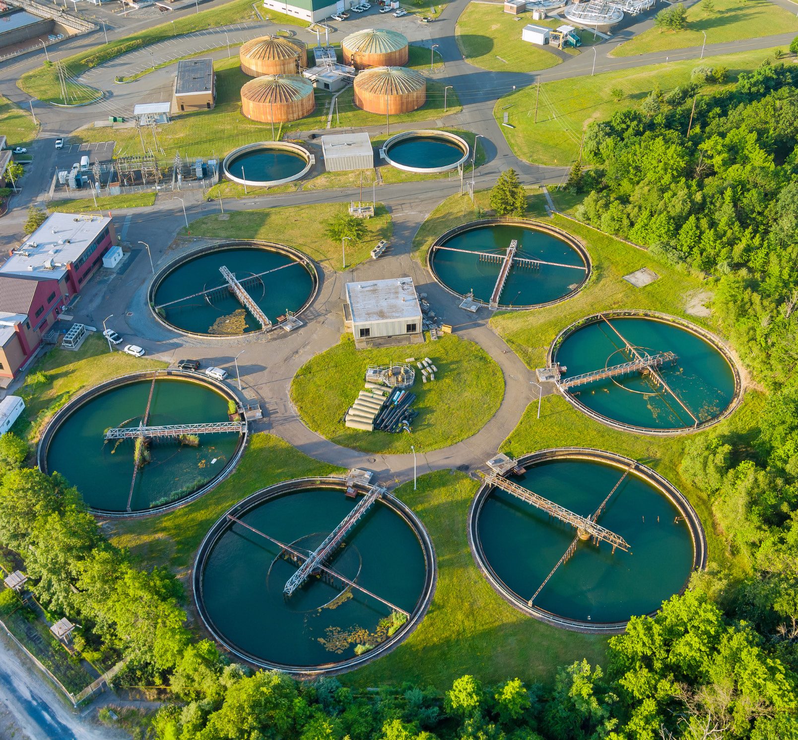 Aerial view of a municipal wastewater treatment plant, circular clarifiers and digesters
